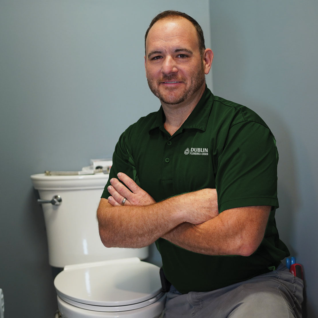 Plumber fixing a toilet