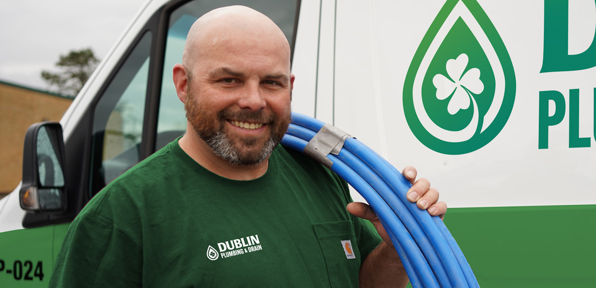 Plumber in front of a Van